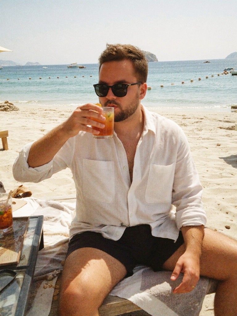 Tretiakov — on the beach in Greece with a cocktail